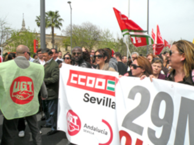Manifestación en Sevilla con pancartas de CCOO y UGT, celebrando el 29M.