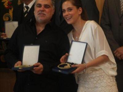 María león muy junto a su madre recoge la medalla de Sevilla para su hermano Paco León