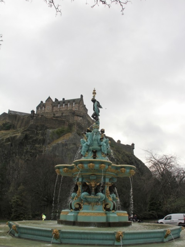 Fountain in Edinburgh with Edinburgh Castle in the background.