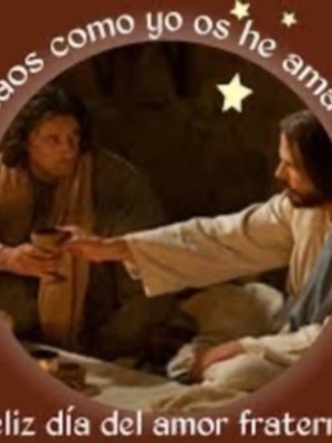 Imagen de dos personas intercambiando un objeto, rodeada por estrellas y el texto "Amos como yo os he amado". Abajo, se lee "Feliz día del amor fraternal" en una frase.